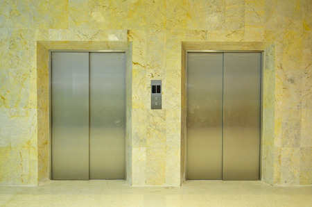 Hallway view of a modern closed elevatorの写真素材