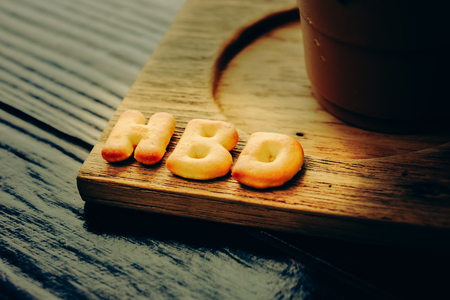 iced coffee and biscuit alphabet spell HBD with rice field backgroundの写真素材