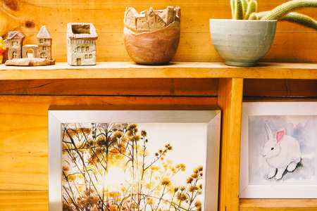 Small clay house model  in woodshelf interior decorateの写真素材