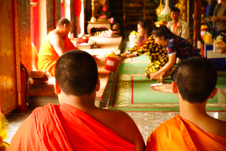 CHIANG MAI, Thailand - August 7 , 2016: Two Young Buddhist novice monk in monastery and people Make a metit in CHIANG MAI, Thailand.のeditorial素材