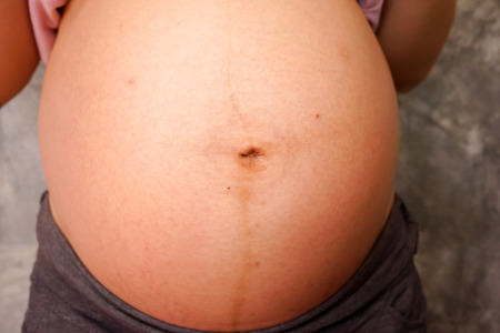 Close up of a cute pregnant bellyの写真素材