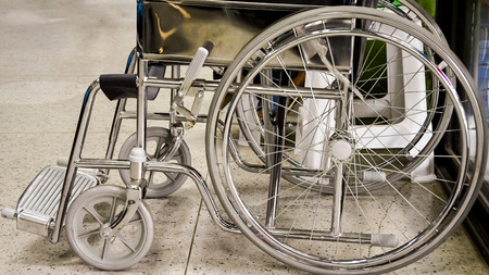Empty wheelchair parked in hospitalの写真素材