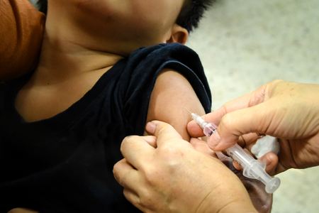 Children receiving vaccine at shoulder .Children vaccine.の写真素材