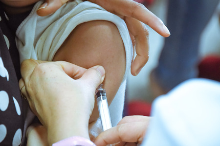 Children receiving vaccine at shoulder .Children vaccine.
