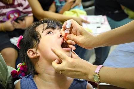CHIANG MAI, Thailand - August 7, 2016:Children receiving vaccine Polic .Children vaccine. CHIANG MAI, Thailand.のeditorial素材