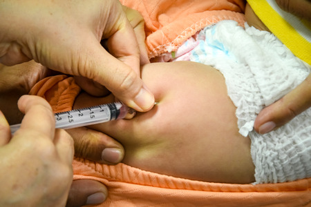 Children receiving vaccine at out side of the thigh.Children vaccine.のeditorial素材