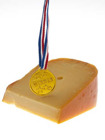 a piece of cheese with a winner badgeの写真素材