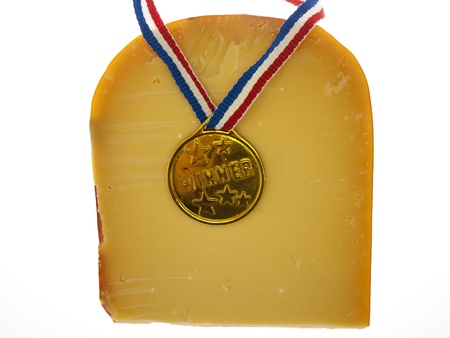 a piece of cheese with a winner badgeの写真素材
