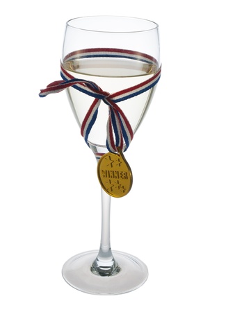 Glass of white wine with medal winner badgeの写真素材