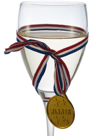 Glass of white wine with medal winner badgeの写真素材