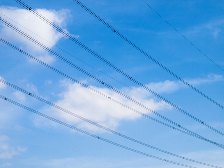 high voltage wires with a blue skyの写真素材