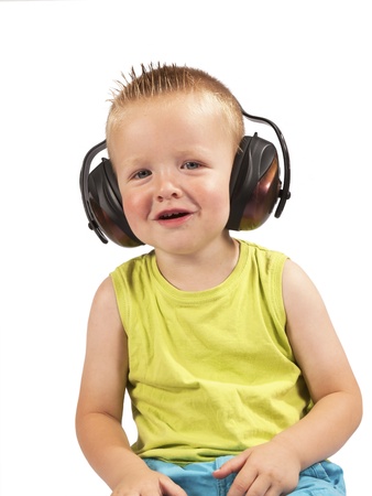 toddler sitting with headphones on his head on a white backgroundの写真素材