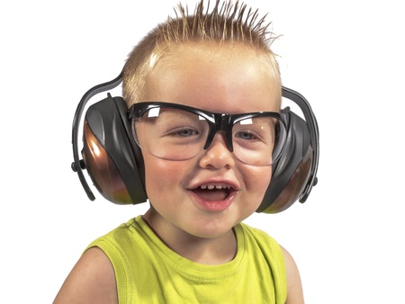 toddler sitting with headphones on his head on a white backgroundの写真素材
