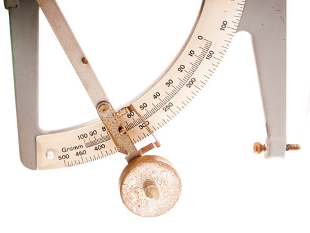 antique postage scale on white background