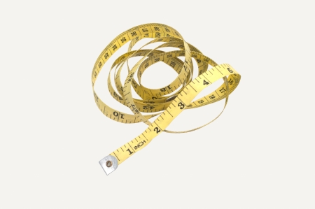 Yellow tape measuring with white backgroundの写真素材