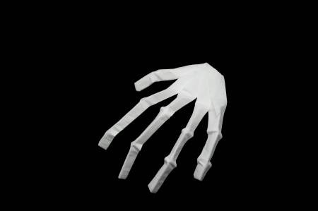 Paper bone hand  with black backgroundの写真素材