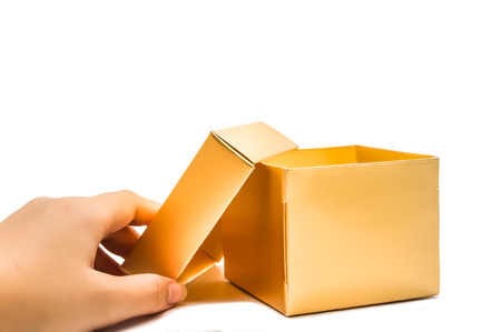 Open golden gift box hand hold isolated on white backgroundの写真素材
