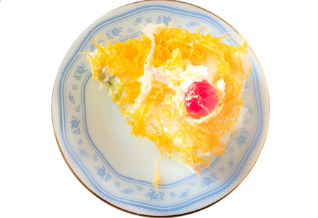 Gold Egg Yolks Thread on coconut cake isolated on white backgroundの写真素材