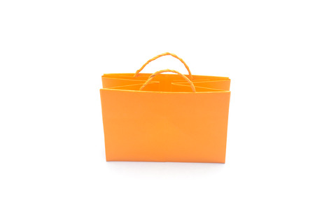 Orange paper bag in white background, shopping bag isolatedの写真素材