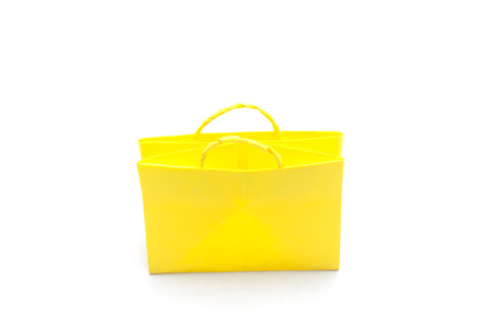 Yellow paper bag in white background, shopping bag isolatedの写真素材