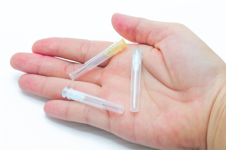 Syringe with needleÂ in handの写真素材