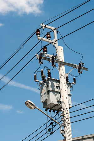 electricity transformer mounted on a tall pole outdoors