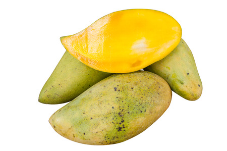 Slices mango in a pile of mangoの写真素材