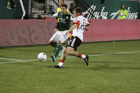Lewis Neal ,DC United and Rodney Wallace  ,Portland Timbers both fight for the ball.