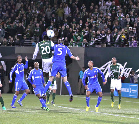 Jose Valencia Timbers Forward & Jeb Brovsky Montreal Défenseur jump for the ball  .のeditorial素材