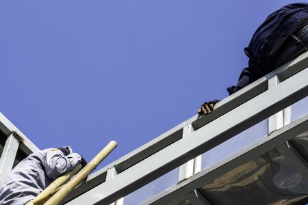 Two man siting and consulting on the roof with Light steel Truss and Frame construction.
