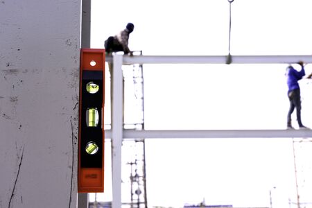 Level tool with red Plastic body and green water bar for precise measurement.の写真素材