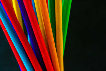 Colorful wood stick closeup with black background.の写真素材