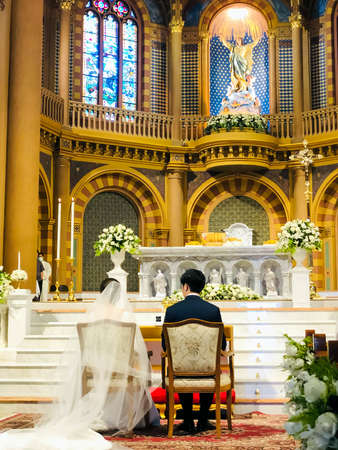 The Bride and Groom's chair in front of the church altar. Church cathedral wedding.の写真素材
