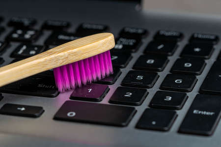 Closeup to colorful of Toothbrush wooden handle Cleaning  the keyboard.