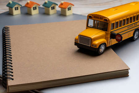 School bus on the Book. Composition school bus model and Note book, Draw and write. Back to School Concept.の写真素材