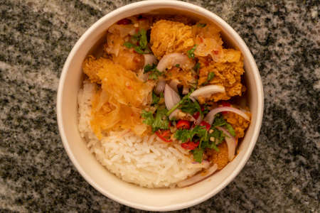 Delicious fried chicken with white rice or stream rice in the bucket. it's Crispy on the outside and soft on the inside. Fried Chicken crunchy on the outside and soft on the inside.の写真素材