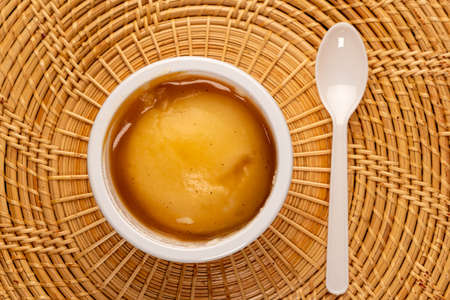 Homemade Mashed Potato with Gravy Sauce in  white bucket isolated on wooden table Mats. Mashed potato or mashed taters.の写真素材