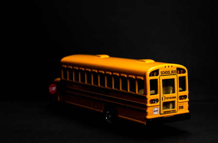 School bus model with stop sign. Do not pass the school bus. The stop signal arm. The stop signal arm. The school bus display a stop signal.の写真素材