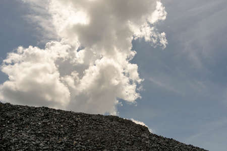 Gravel pile used to make concrete , to mix with asphalt , to create road or path, to create floor and  garden, gravel pine. texture , backgrounds and isolated. with blue sky.の写真素材
