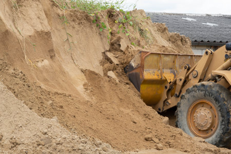 Many diffrent name of Wheel loader ,  Skip Loader , scoop loader or even a bucket loader, This machine lifting sand.の写真素材