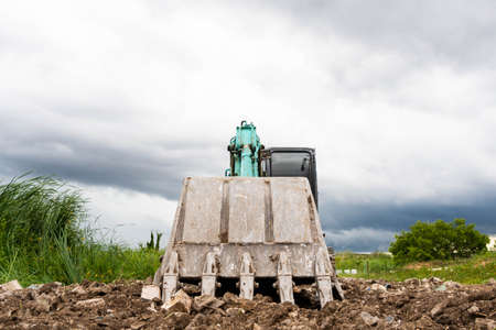 Hydraulic Excavator stopped working and and put the bucket on the ground.の写真素材