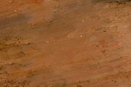 Dig up the ground by bucket of excavator or backhoe. The soil is earth tone.の写真素材