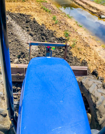 The tractor is adjusting the soil with front dozer, slow speed, Over the front top view.の写真素材