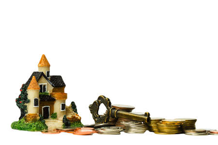 Coins and Tiny house with key. Escrow service Concept ideas. sale and purchase of real estate. Isolated on white background. copy space.の写真素材