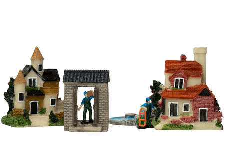 Delivery Model in the uniform blue and green with cap carrying a box and dolly. IN front of the house.  Moving and Storage services business ideas.の写真素材