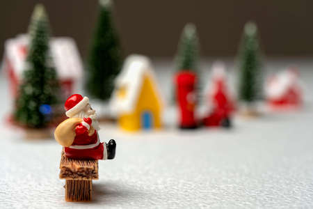 Santa Claus carrying a bag sitting on a bench.の写真素材
