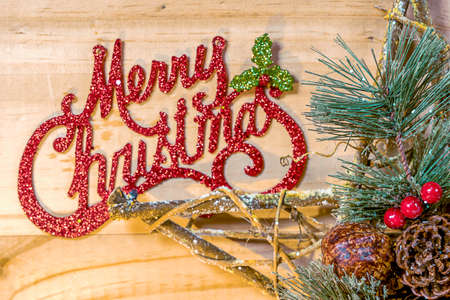 Bell and Star Christmas concept on wooden plank background.