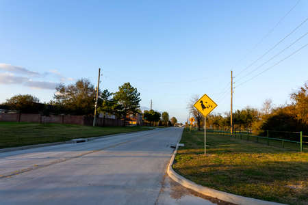 Duck zone warning sign shape of rhombus in back and yellow with duck family icon, transportation in the katy park , Texas ,USAの写真素材