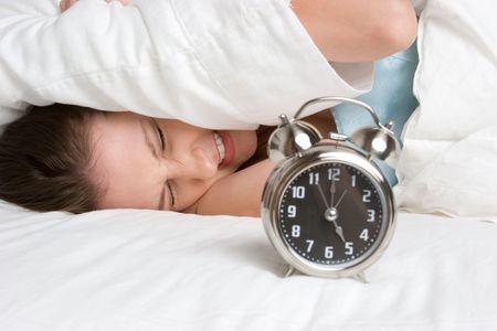 Woman Waking Up to Alarmの写真素材
