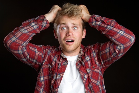 Young frustrated man pulling hair